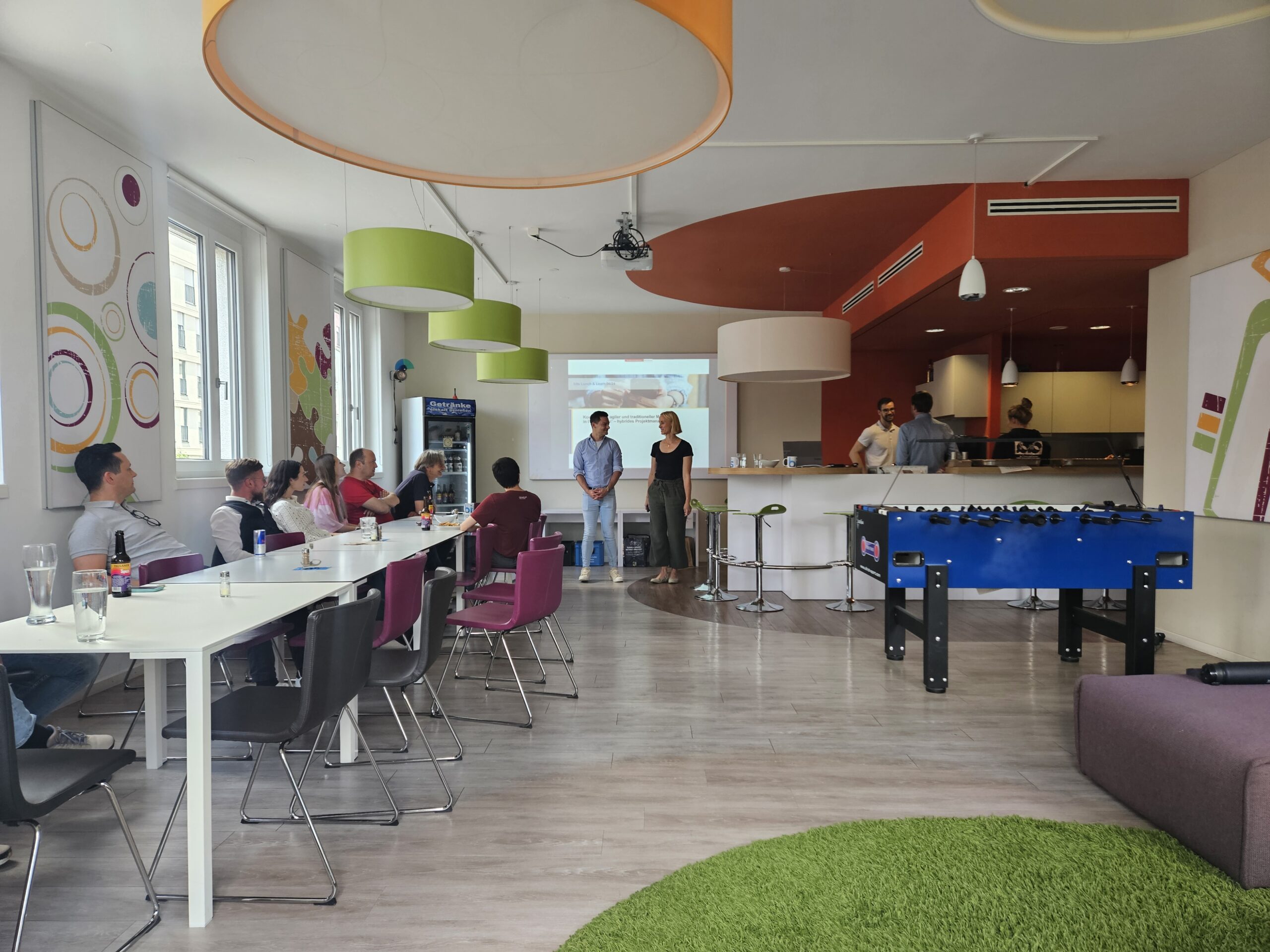 a group of people in a room with tables and chairs